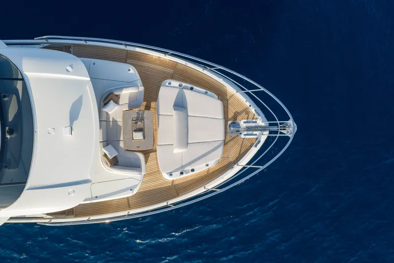Slide: The Image of Aerial view of 2027 Absolute Navetta 66 yacht's deck over blue ocean waters. - 67