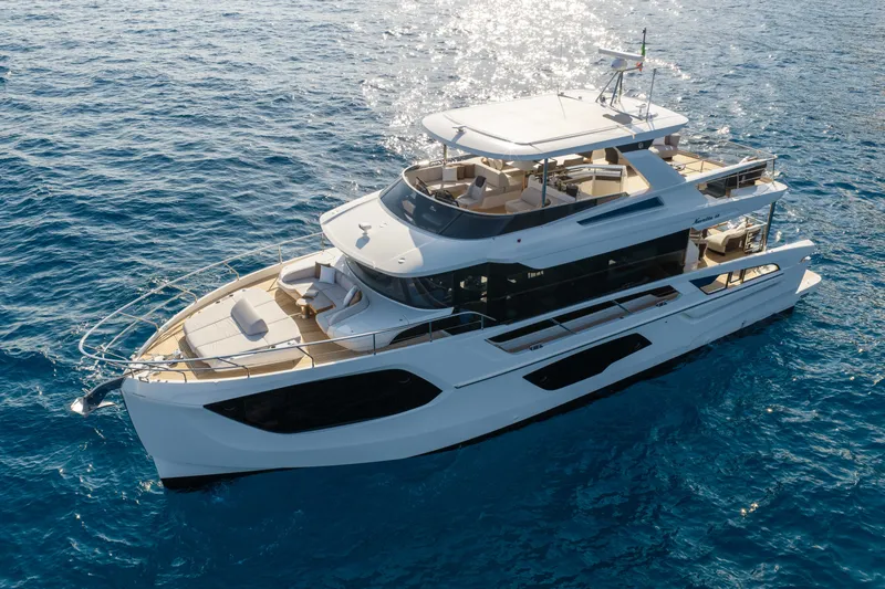 Slide: The Image of Luxurious 2027 Absolute Navetta 66 yacht cruising on clear blue ocean waters. - 14