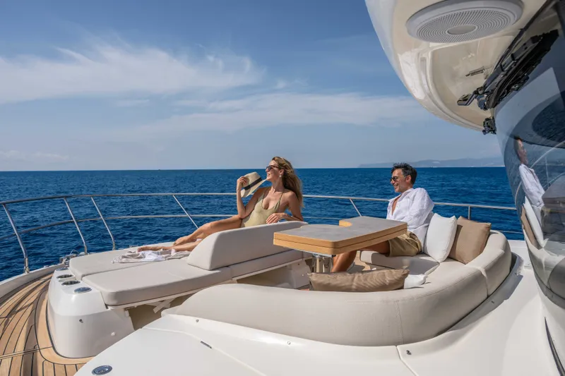 Slide: The Image of Couple relaxing on Absolute Navetta 66 yacht, 2027 model, enjoying ocean views. - 27