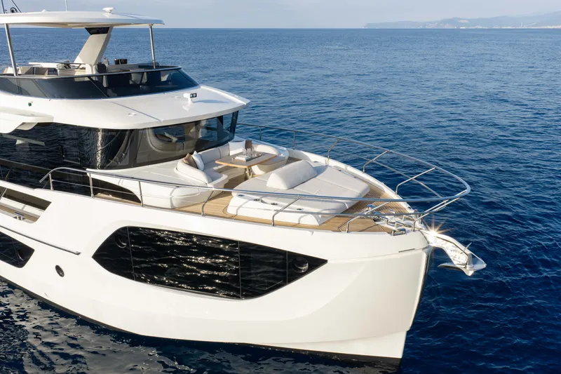 Slide: The Image of Luxurious 2027 Absolute Navetta 66 yacht cruising on open sea. - 66
