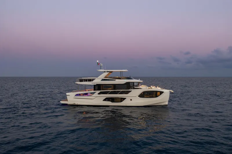 Slide: The Image of Luxurious 2027 Absolute Navetta 66 yacht cruising at sunset on open sea. - 16