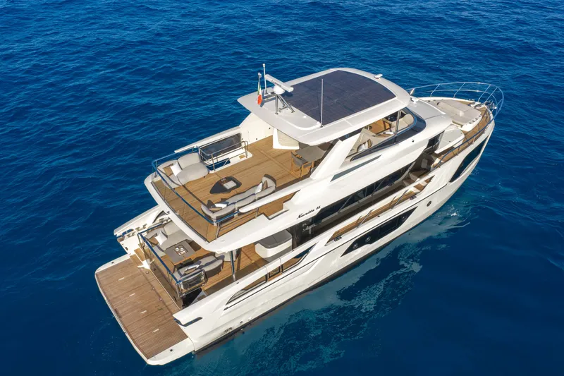 Slide: The Image of 2027 Absolute Navetta 66 yacht cruising on clear blue ocean waters. - 12