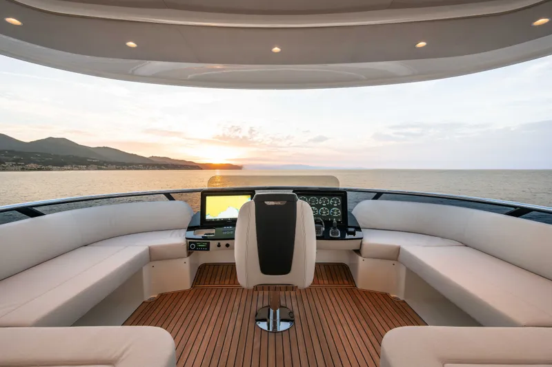 Slide: The Image of Luxurious helm of 2027 Absolute Navetta 66 yacht at sunset, featuring plush seating and advanced controls. - 33