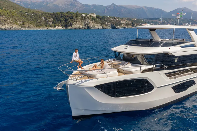 Slide: The Image of Luxurious 2027 Absolute Navetta 66 yacht cruising in scenic coastal waters. - 6
