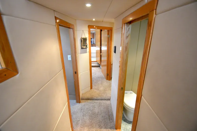 Slide: The Image of Interior of a 2004 Chesapeake 58 boat with carpet and wooden doors. - 18