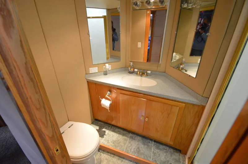 Slide: The Image of Bathroom in 2004 Chesapeake 58 boat with wood cabinets and mirror. - 21