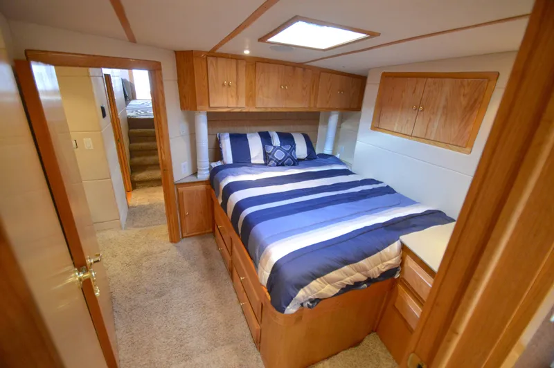 Slide: The Image of Bedroom in 2004 Chesapeake 58 boat with wooden furnishings. - 25
