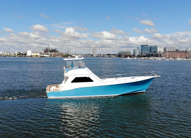 Slide: The Image of 2004 Chesapeake 58 boat on calm water with city skyline. - 48