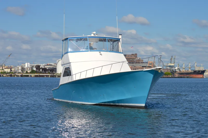 Slide: The Image of 2004 Chesapeake 58 boat on calm water with cityscape background. - 7