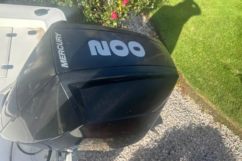 Slide: The Image of Mercury outboard engine on 2006 Mako 224 Center Console boat, garden background. - 4