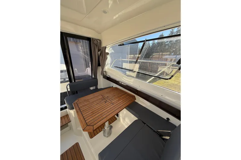 Slide: The Image of Interior of 2023 Parker Poland 660 Weekend boat with wooden table and seating. - 10