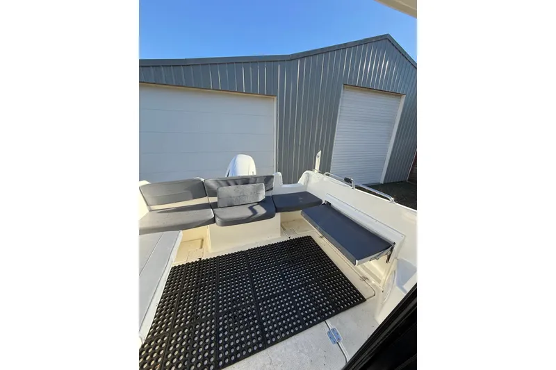 Slide: The Image of 2023 Parker Poland 660 Weekend boat interior with cushioned seating and non-slip flooring. - 13