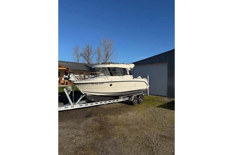 Slide: The Image of 2023 Parker Poland 660 Weekend boat on trailer, parked outdoors. - 15