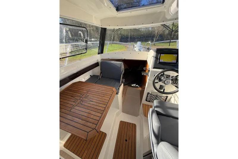 Slide: The Image of Interior of 2023 Parker Poland 660 Weekend boat with wooden table and steering wheel. - 3