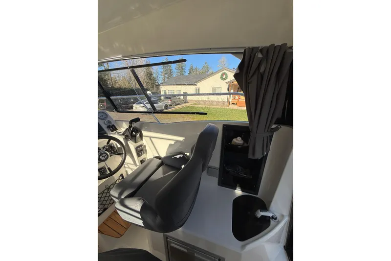 Slide: The Image of Interior of 2023 Parker Poland 660 Weekend boat with steering wheel and seating. - 5