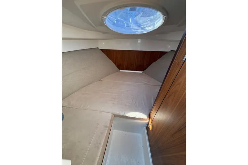 Slide: The Image of Interior cabin of 2023 Parker Poland 660 Weekend boat with cozy bedding and wooden accents. - 7