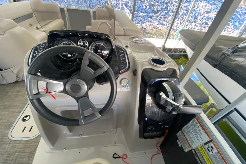 Slide: The Image of 2017 Princecraft Quorum 25XT boat dashboard with steering wheel and controls. - 21