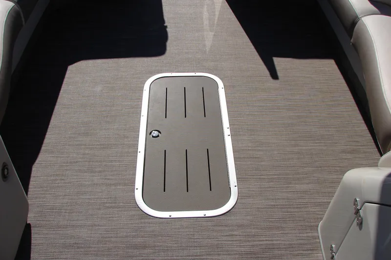 Slide: The Image of 2021 Bennington QX 30 boat interior with sleek flooring and storage hatch. - 20