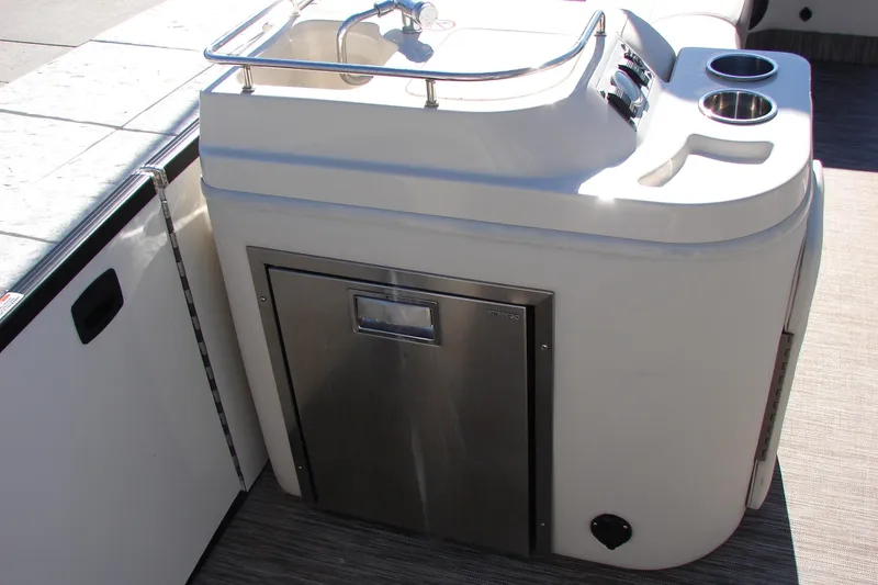 Slide: The Image of 2021 Bennington QX 30 boat interior with sink and stainless steel storage. - 21