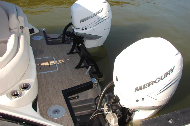 Slide: The Image of 2021 Bennington QX 30 boat with dual Mercury outboard engines on water. - 23