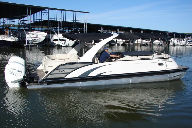Slide: The Image of 2021 Bennington QX 30 QXFBWA X2 Wide Beam pontoon boat on water, docked at marina. - 4