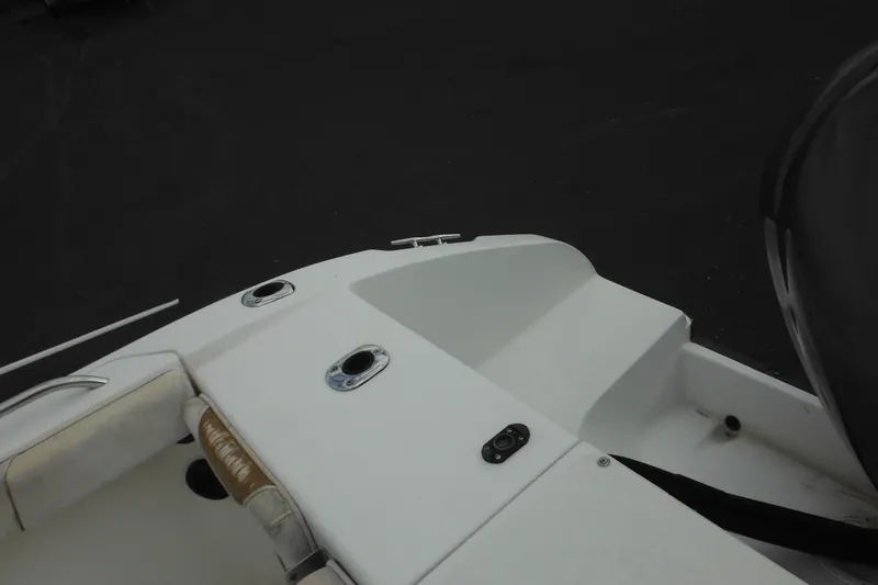 Slide: The Image of 2006 Seaswirl Striper 2301 Dual Console O/B boat deck, featuring seating and rod holders. - 15