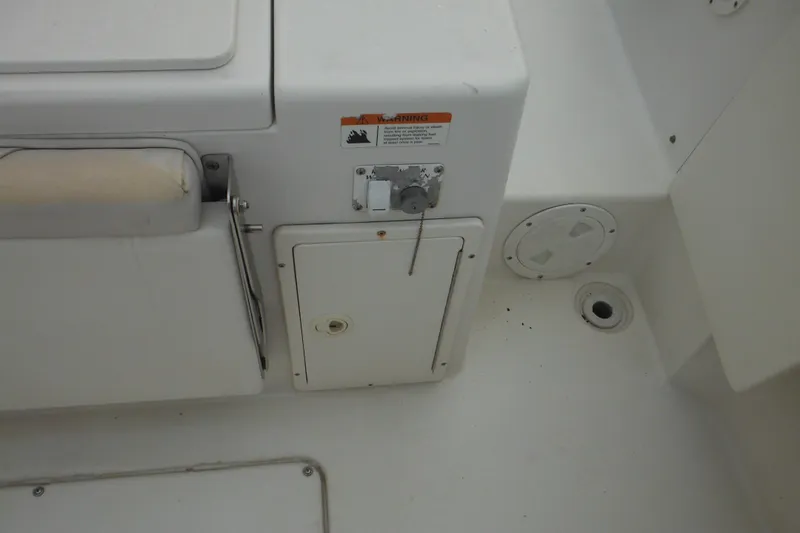 Slide: The Image of 2006 Seaswirl Striper 2301 Dual Console O/B boat interior, featuring storage compartments and drainage. - 19