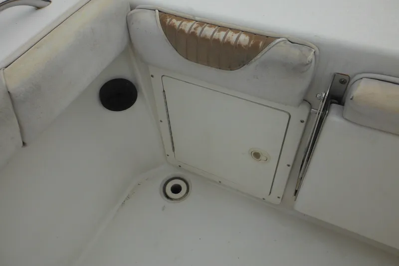Slide: The Image of 2006 Seaswirl Striper 2301 Dual Console O/B interior seating and storage compartment. - 21