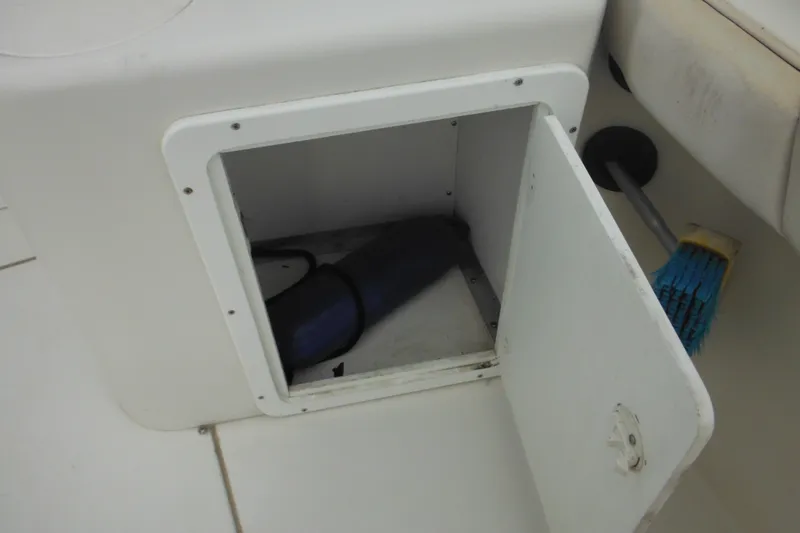 Slide: The Image of Open storage compartment on 2006 Seaswirl Striper 2301 Dual Console boat. - 27