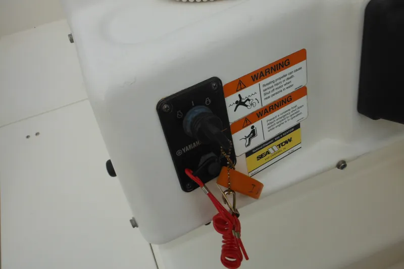 Slide: The Image of 2006 Seaswirl Striper 2301 Dual Console O/B ignition switch with safety warnings. - 37