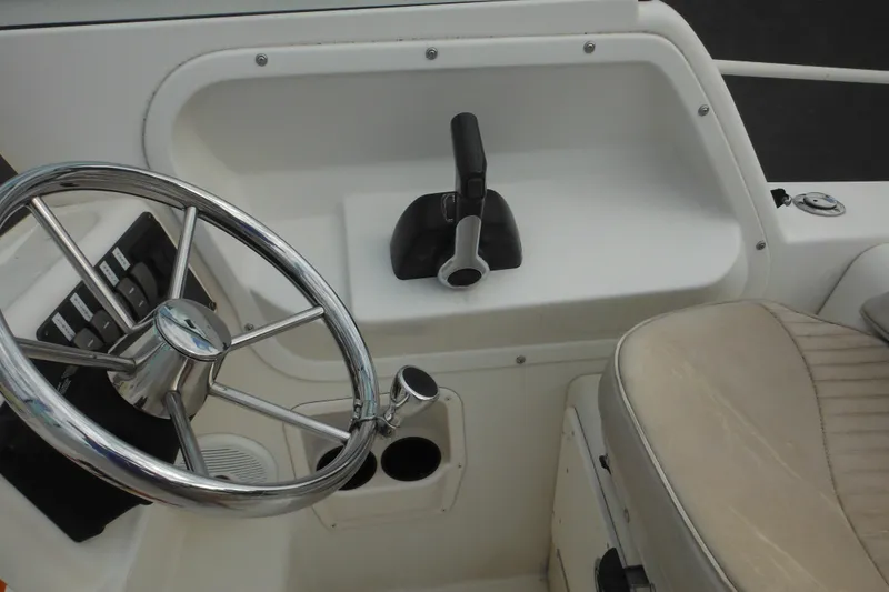 Slide: The Image of 2006 Seaswirl Striper 2301 Dual Console O/B helm with steering wheel and throttle controls. - 38