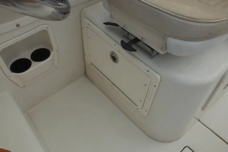 Slide: The Image of 2006 Seaswirl Striper 2301 Dual Console O/B interior with storage compartment and cup holders. - 39