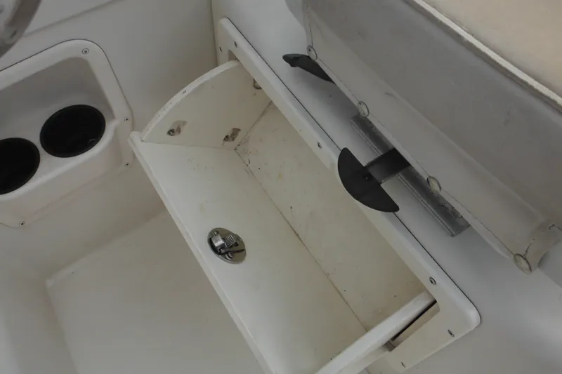 Slide: The Image of 2006 Seaswirl Striper 2301 Dual Console O/B interior storage compartment with cup holders. - 40