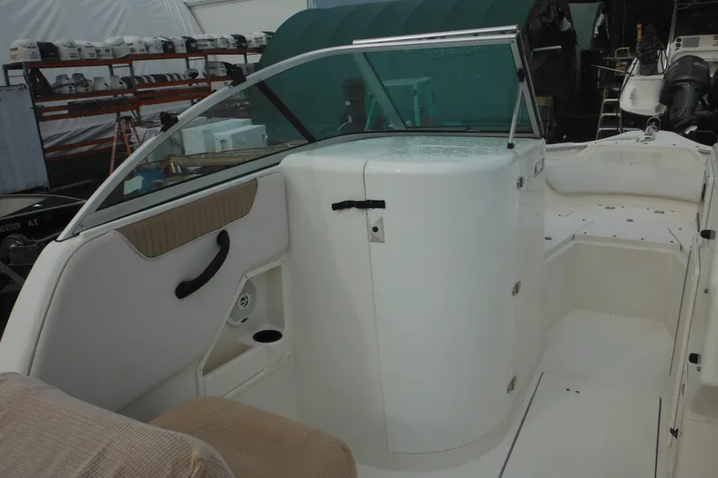 Slide: The Image of 2006 Seaswirl Striper 2301 Dual Console O/B interior with seating and storage compartments. - 50