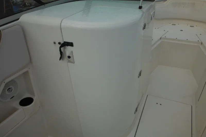 Slide: The Image of 2006 Seaswirl Striper 2301 Dual Console O/B interior with storage compartment and seating area. - 51