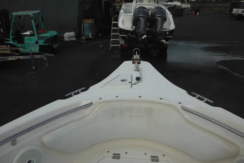 Slide: The Image of 2006 Seaswirl Striper 2301 Dual Console O/B boat in a marina setting. - 55