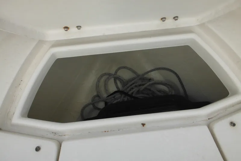 Slide: The Image of Storage compartment with rope on 2006 Seaswirl Striper 2301 Dual Console O/B boat. - 62