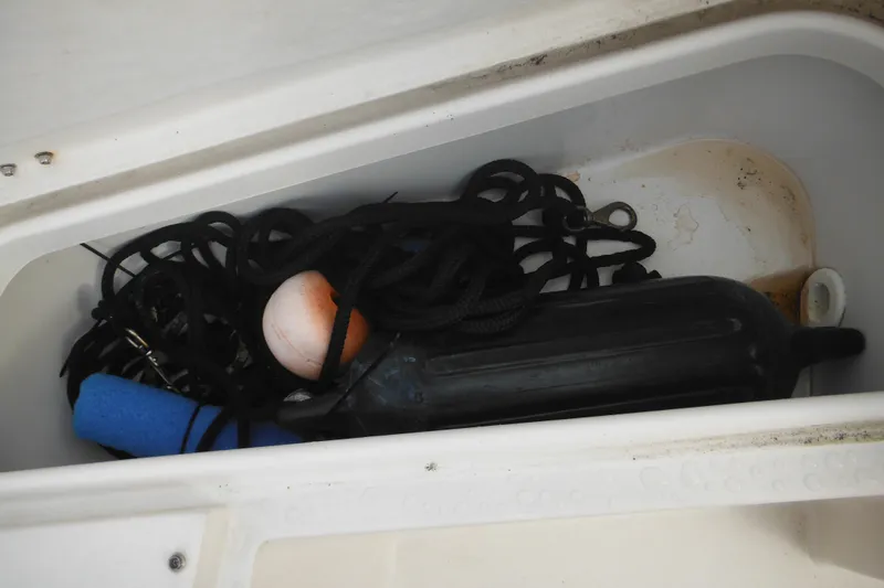 Slide: The Image of Storage compartment of 2006 Seaswirl Striper 2301 with ropes and boating gear. - 63