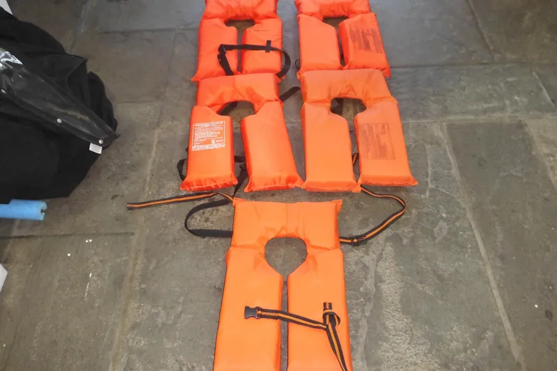 Slide: The Image of Orange life jackets on a stone floor, suitable for Seaswirl Striper 2301 Dual Console O/B 2006. - 64