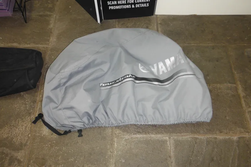 Slide: The Image of Gray Yamaha Four Stroke engine cover on stone floor, related to 2006 Seaswirl Striper 2301. - 69