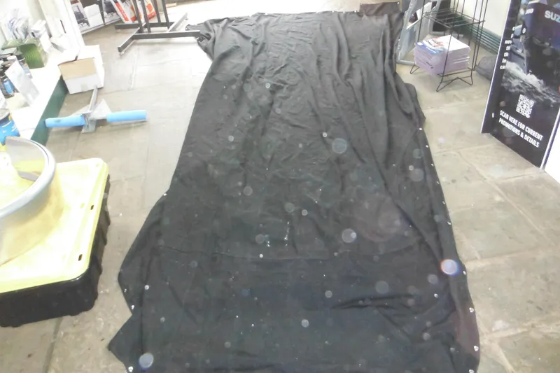 Slide: The Image of Black tarp on floor in a workshop with various tools and equipment. - 72