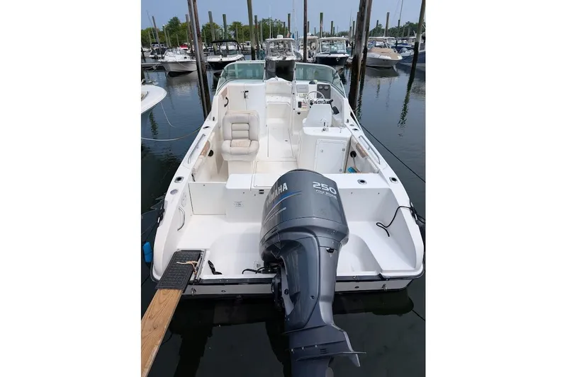 Slide: The Image of 2006 Seaswirl Striper 2301 Dual Console O/B boat docked in marina. - 80