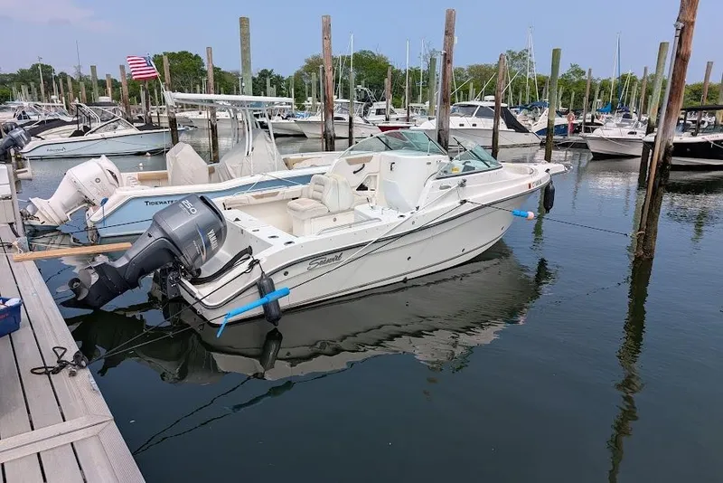 Slide: The Image of 2006 Seaswirl Striper 2301 Dual Console O/B docked at marina, surrounded by boats. - 81