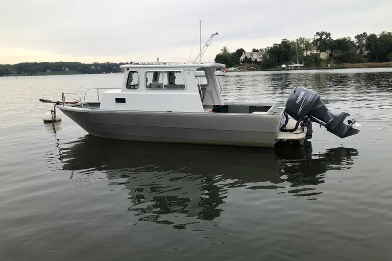 Slide: The Image of 2002 Scorpion Lynx boat with Yamaha outboard motor on calm lake. - 1