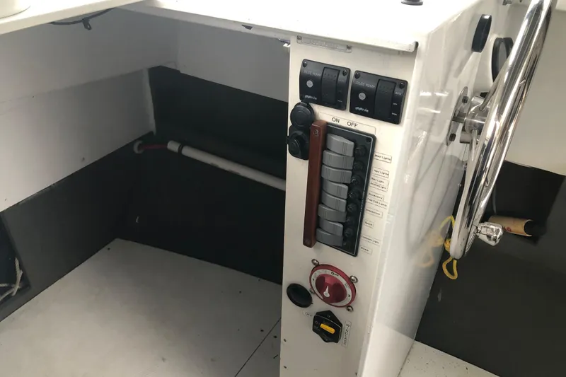 Slide: The Image of 2002 Scorpion Lynx boat control panel with steering wheel and switches. - 15