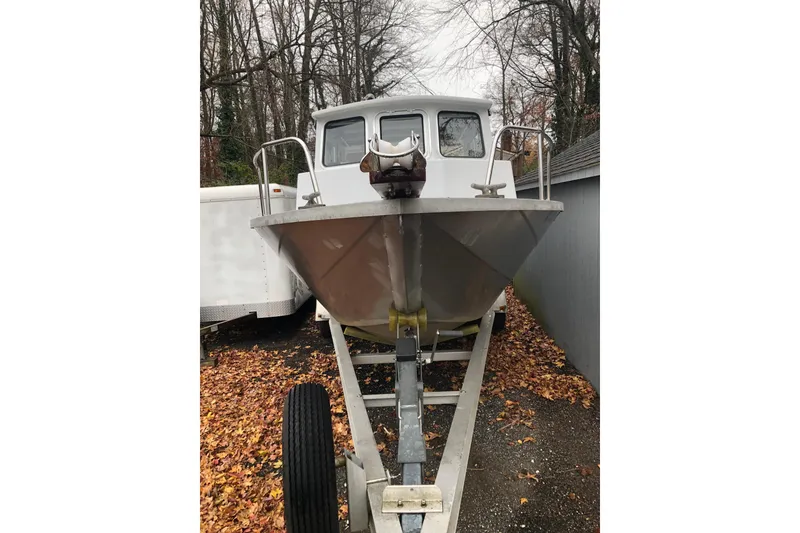 Slide: The Image of 2002 Scorpion Lynx boat on trailer, surrounded by autumn leaves. - 18