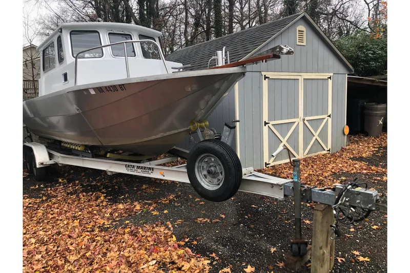 Slide: The Image of 2002 Scorpion Lynx boat on trailer beside a shed, surrounded by autumn leaves. - 5