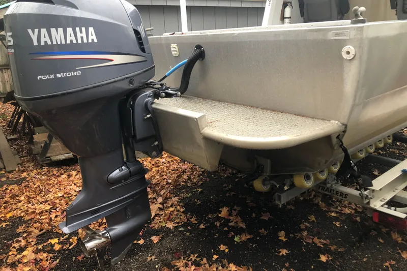 Slide: The Image of Boat with Yamaha 115 four-stroke engine on trailer, surrounded by autumn leaves. - 6
