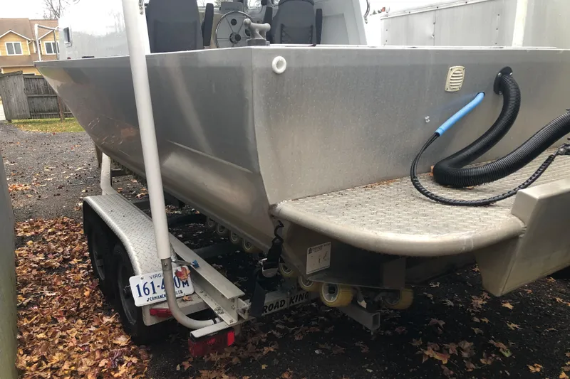 Slide: The Image of 2002 Scorpion Lynx boat on trailer, parked outdoors with fallen leaves. - 7