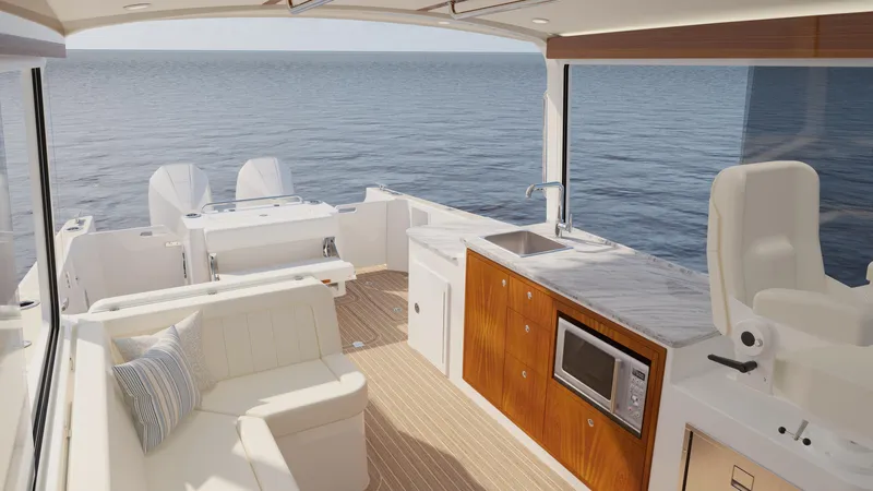 Slide: The Image of Luxurious interior of 2026 MJM 38R yacht with ocean view, featuring seating and kitchenette. - 6